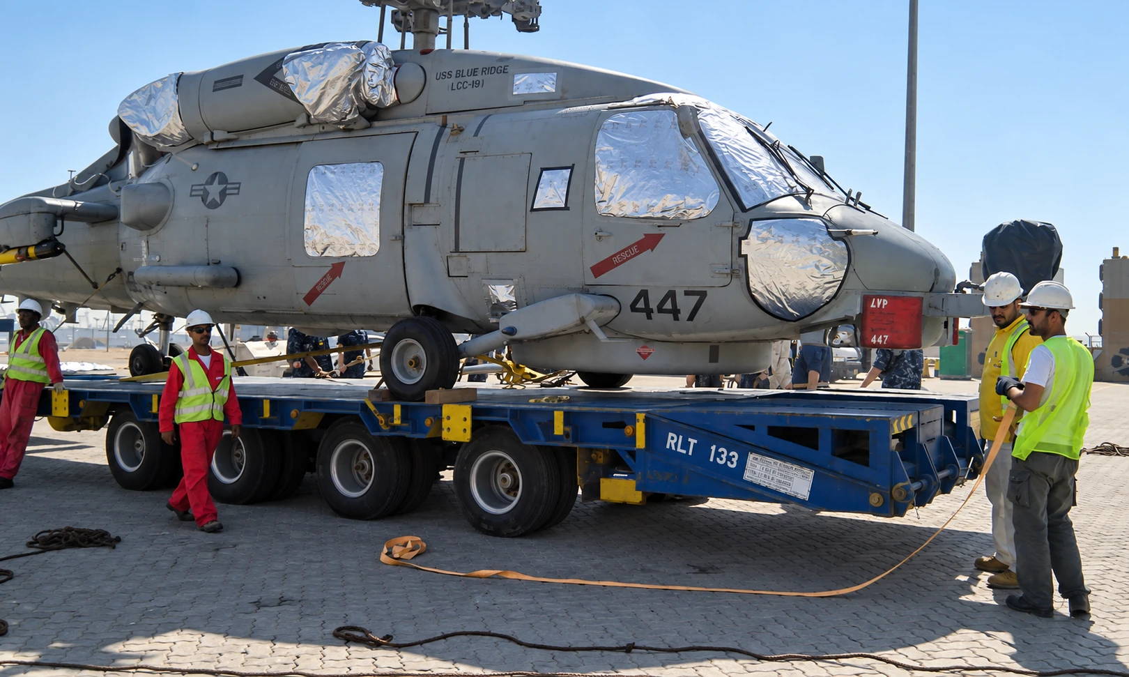 A military helicopter secured on an ADSO low-bed trailer